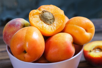 apricots in a bowl on wooden table