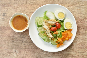 Islamic salad vegetable and boiled egg topping crispy fried taro dressing sweet bean sauce halal food on plate