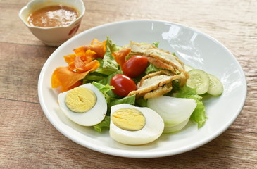 Islamic salad vegetable and boiled egg topping crispy fried taro dressing sweet bean sauce halal food on plate
