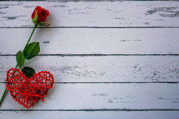 Red hearts and flowers on a white wood floor with space, ideas love or the day of love Valentines Day.