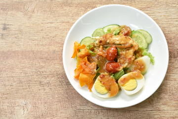 Islamic salad vegetable and boiled egg topping crispy fried taro dressing sweet bean sauce halal food on plate