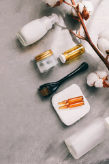 Dermaroller and serum next to an anti aging face cream Beauty industry Close-up  Dermaroller for medical micro needling therapy Derma roller mesoroller for mesotherapy  Copy space Selective focus