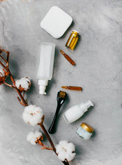 Dermaroller and serum next to an anti aging face cream Beauty industry Close-up  Dermaroller for medical micro needling therapy Derma roller mesoroller for mesotherapy  Copy space Selective focus