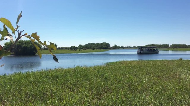 River boat sailing over Yellow Water swamp in Kakadu National Park in the Territory of Australia.
