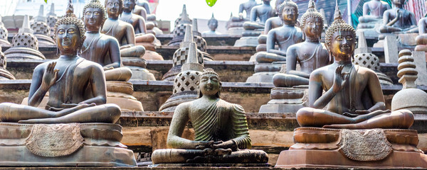 Buddha statues and small stupas in Gangaramaya temple, Colombo, Sri Lanka.