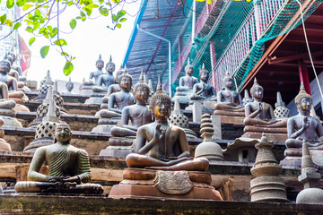 Buddha statues and small stupas in Gangaramaya temple, Colombo, Sri Lanka.