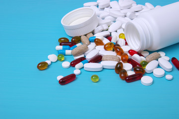 Colorful pills and tablets on blue
