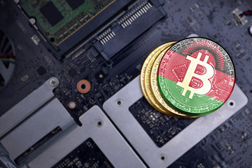golden bitcoins with flag of malawi on a computer electronic circuit board. bitcoin mining concept.