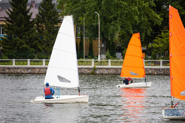 single small sailing boats on the lake