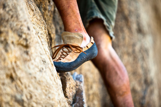 Low section of man climbing on rock