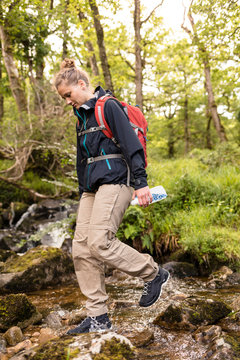 Glenveagh National Park, Donegal, Ireland: A woman with a water filter .