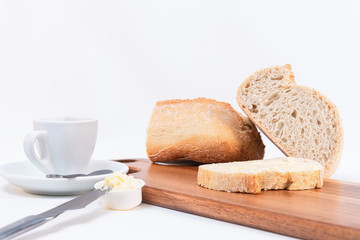 cereal bread slices with butter and jar with homemade jam closeup on rustic wooden table. White background.