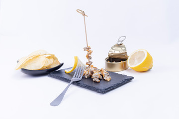 Delicious cockles brochette served with fries and fresh lemon.