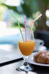 Delicious orange juice for breakfast with bread rolls - On a natural, unfocused background
