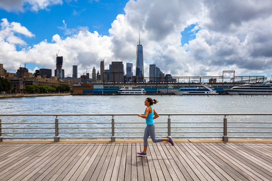 A woman runs along the Hudson River Park Pier 45 near downtown Manhattan in New York City.
