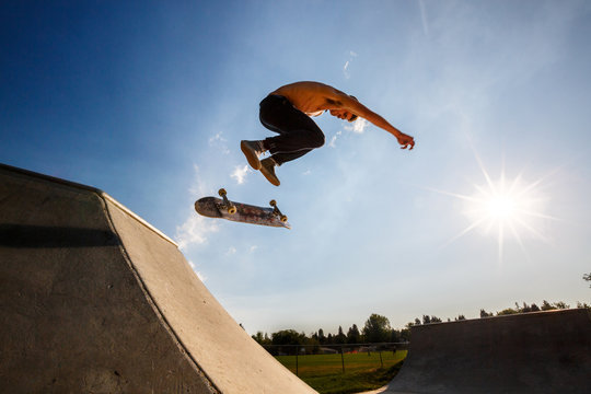 Shirtless man skateboarding at skate park
