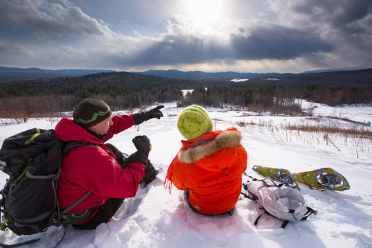 A man and woman take a hot tea break while snowshoeing in the newly-aquired 1,300 acre parcel of land at the south end of the Green Hills Preserve. The addition expanded the overall uninterrupted acreage of the preserve to 5,500 acres and as an important watershed and drainage basin for the Saco River is an important habitat for deer, black bear, moose, bobcat, fisher, brook trout, mink, beavers and  more. Portions of the acreage are undergoing revegetation and restoration of native plant species.