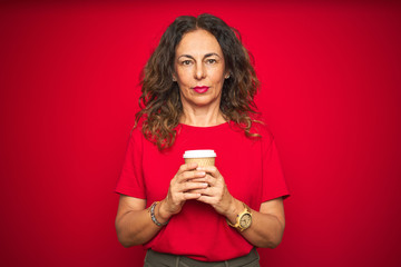 Middle age senior woman drinking a cup of coffee over red isolated background with a confident expression on smart face thinking serious