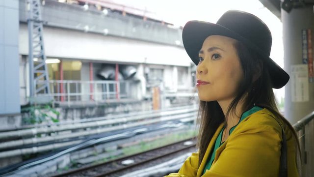 Japanese woman waiting for a train in Tokyo Japan