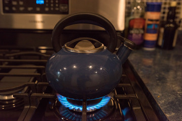 blue tea kettle on blue flame