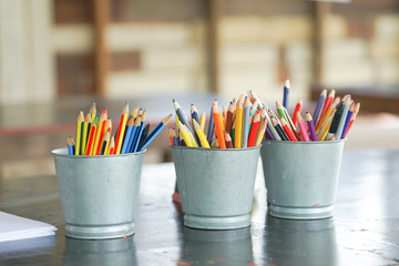 Closeup blunted color pencils in metal buckets
