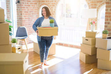 Fototapeta na wymiar Young beautiful plus size woman moving to a new house, holding cardboxes smiling very happy for new apartment