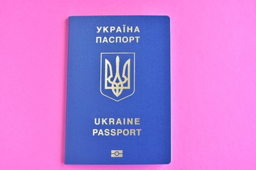 Biomedical Ukraine id passport on bright magenta background with selective focus and empty space for photo or text. Ukrainian id passport with a golden symbol trident on blue backdrop. Copy space 