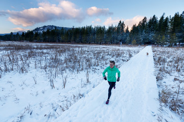 A woman and her dog Tink go for a cold winter run at the Balto Dog Park along the Pond Oreille River near Sandpoint, Idaho.