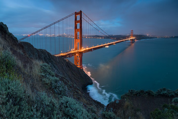 Classic panoramic view of famous Golden Gate Bridge in beautiful evening light on a dusk with blue sky and clouds in summer or autumn, San Francisco, California, USA