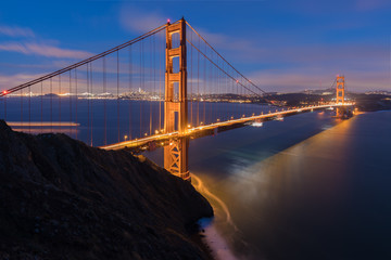 Classic panoramic view of famous Golden Gate Bridge in beautiful evening light on a dusk with blue sky and clouds in summer or autumn, San Francisco, California, USA