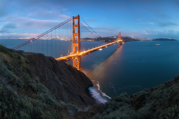 Classic panoramic view of famous Golden Gate Bridge in beautiful evening light on a dusk with blue...