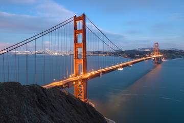 Fototapeta na wymiar Classic panoramic view of famous Golden Gate Bridge in beautiful evening light on a dusk with blue sky and clouds in summer or autumn, San Francisco, California, USA