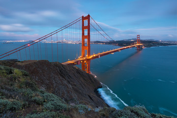 Classic panoramic view of famous Golden Gate Bridge in beautiful evening light on a dusk with blue sky and clouds in summer or autumn, San Francisco, California, USA