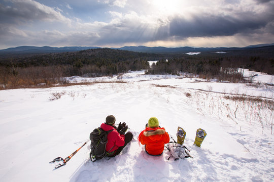 A man and woman take a hot tea break while snowshoeing in the newly-aquired 1,300 acre parcel of land at the south end of the Green Hills Preserve. The addition expanded the overall uninterrupted acreage of the preserve to 5,500 acres and as an important watershed and drainage basin for the Saco River is an important habitat for deer, black bear, moose, bobcat, fisher, brook trout, mink, beavers and  more. Portions of the acreage are undergoing revegetation and restoration of native plant species.