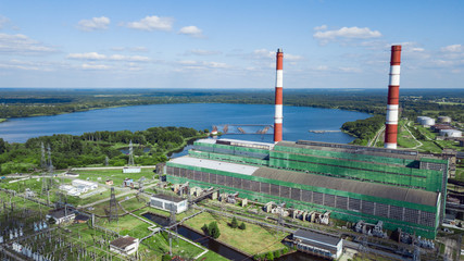 Fototapeta na wymiar Industrial plant on the background of the lake. Thermal power plant and electricity. Technology and ecology. Photo from the drone.