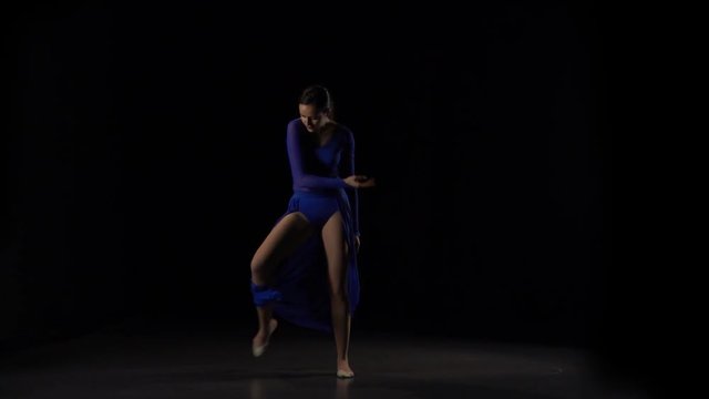 Slow motion of young sexy ballerina dancing elements of ballet.