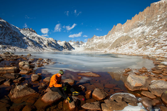 Craig Pope pumps some water using an MSR filter at one of the many beautiful Titcomb Lakes in the Titcomb Basin deep in the Wind River Range in Wyoming.     