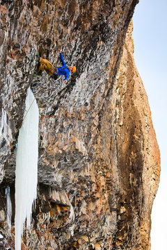 A man  on Roman Candle (M9), a sustained, overhanging mixed route at Hyalite Canyon in Montana.