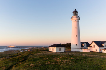 Hirtshals, Nordjylland, Denmark: The lighthouse with the campsite and a "ColorLine" ferry from Norway entering the harbour in the background.