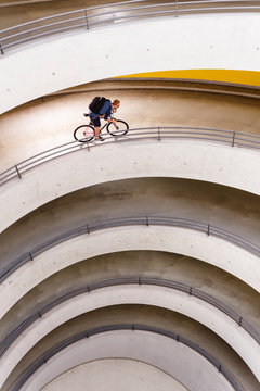 Stuttgart, Baden-W&cedil;rttemberg, Germany: Male cyclist Jens Kraft on his fixed gear bike in the parking garage.