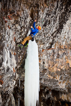 A man on Roman Candle (M9), a sustained, overhanging mixed route at Hyalite Canyon in Montana.