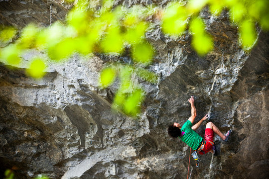 A man climbs Tractor Boy 5.13c in The Ampitheater, a small limestone crag near Riggins, Idaho in the foothills of the Seven Devils Mountains.