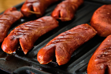 Sliced sausage on grill