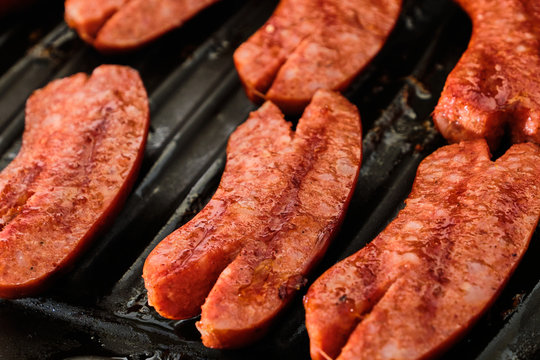 Sliced sausage on grill