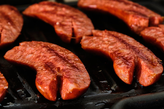 Sliced sausage on grill
