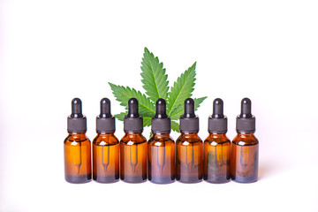Bottles of cannabis or CBD oil derived from marijuana plant isolated over white background