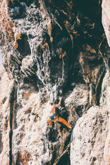 Rock climbing on natural terrain.