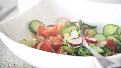 Summer fresh vegetable salad cucumber tomato and radishes vegetarian food vitamin