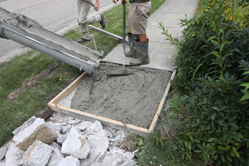concrete work is being performed at a home in a urban neighborhood