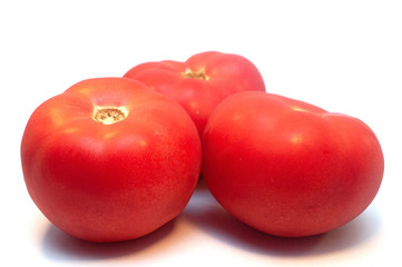 Red ripe tomatoes isolated on white background